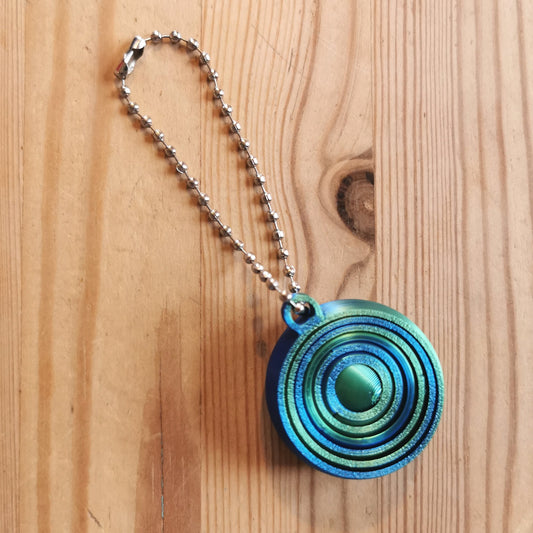 Spiraalifidget avaimenperä liukuvärjätty sinivihreä